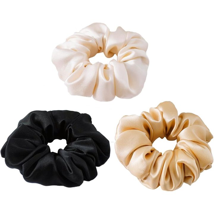 Three large silk scrunchies in black, apricot and champagne